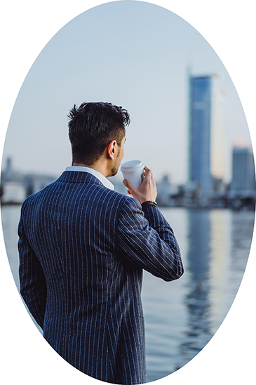 young male businessman in the city drinks morning coffee calls o